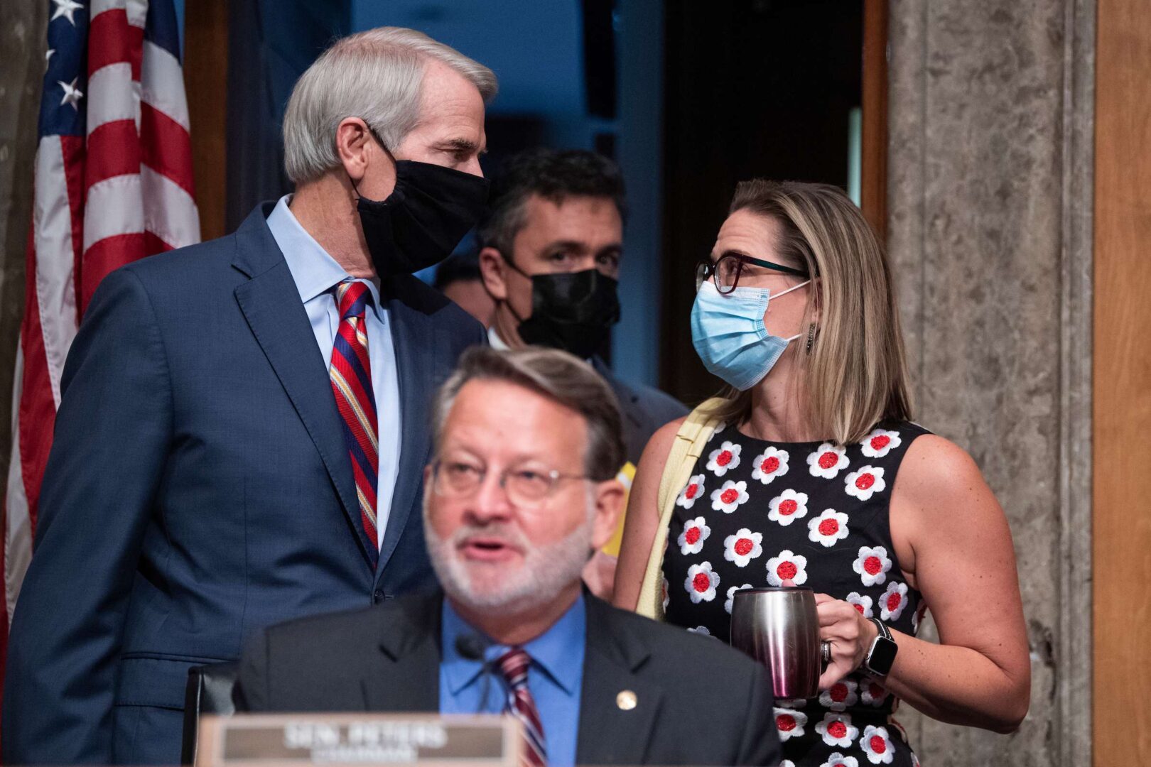 Sens. Rob Portman, R-Ohio, and Kyrsten Sinema, D-Ariz., both standing, led the 22 lawmakers who negotiated the infrastructure bill. 
