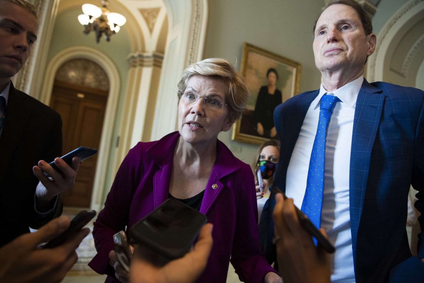 Sen. Elizabeth Warren, D-Mass., and Sen. Ron Wyden, D-Ore., talk with reporters on the debt ceiling on July 21, 2021.