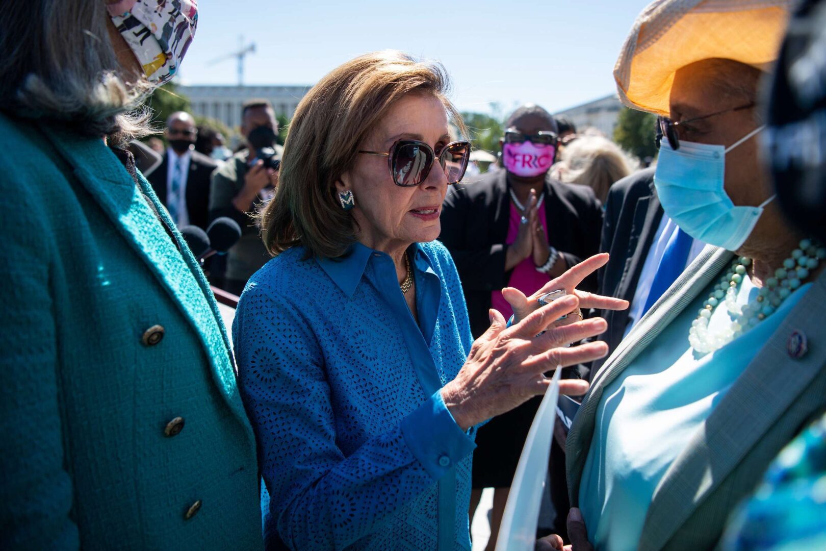 Speaker Nancy Pelosi speaks with Rep. Alma Adams, D-N.C., right, during a Build Back Better for Women rally on the House steps of the Capitol on  Sept. 24. 