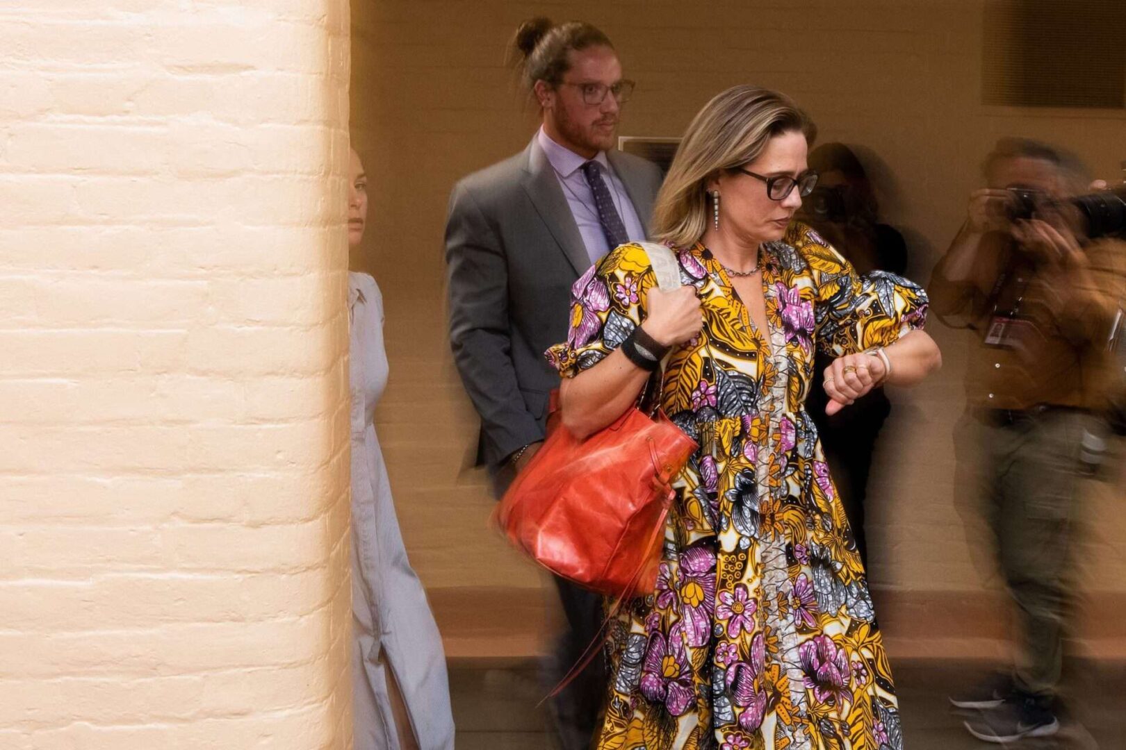 Sen. Kyrsten Sinema, D-Ariz., checks her watch as she leaves her hideaway office to go vote in the Capitol on Tuesday, August 2. 