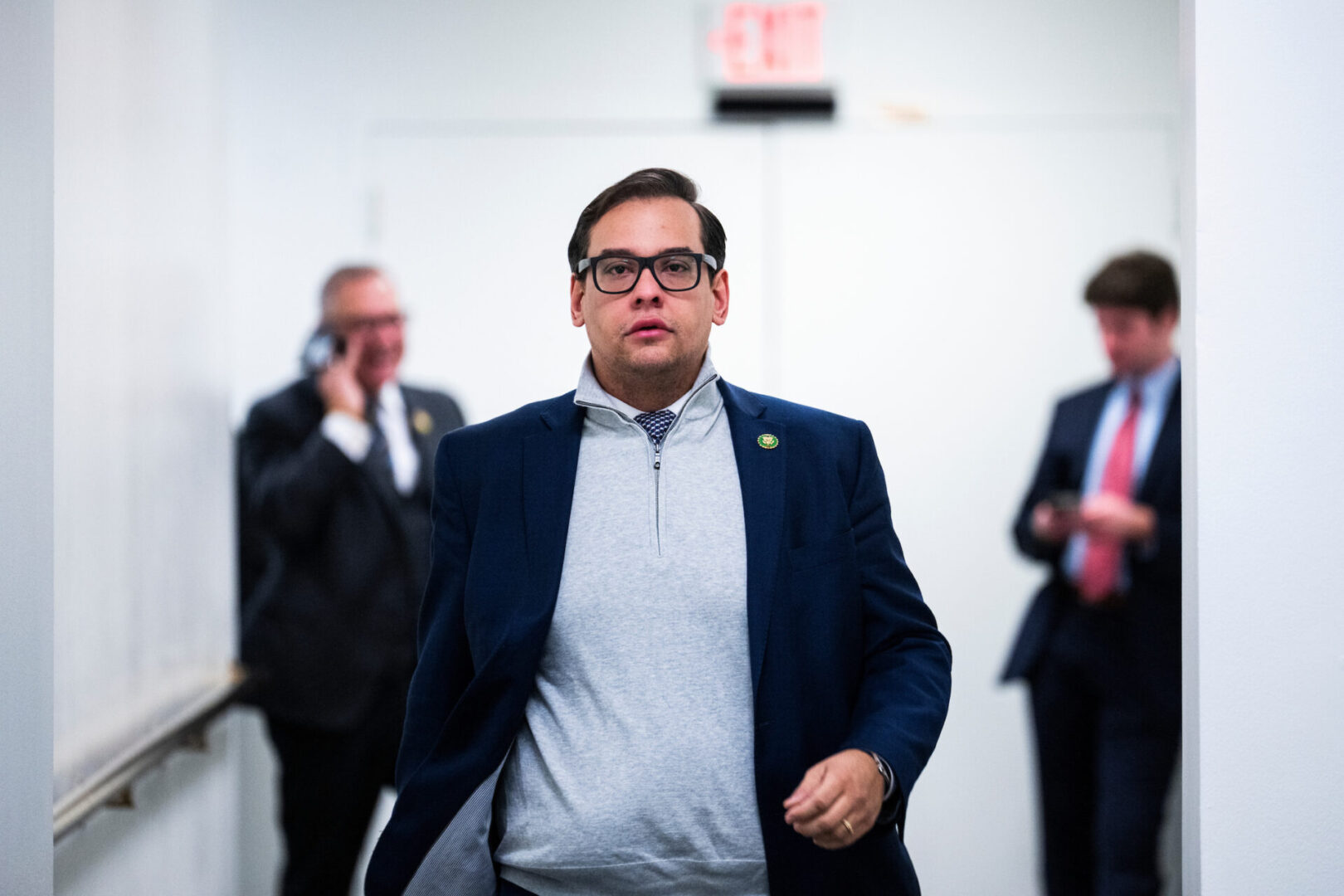 Rep. George Santos, R-N.Y., walks outside a House Republican Conference meeting in the Capitol on Tuesday. 