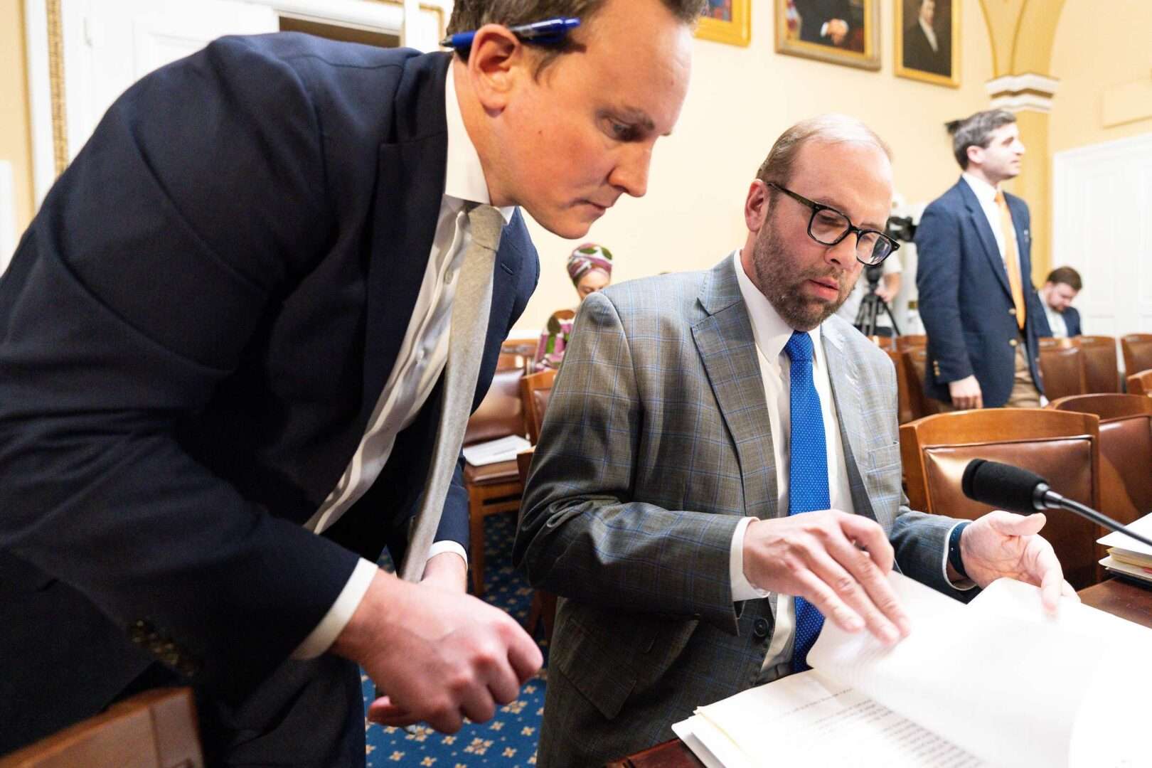 House Ways and Means Chairman Jason Smith, R-Mo., right, confers with an aide before the start of the House Rules Committee meeting on the debt limit bill on Tuesday.