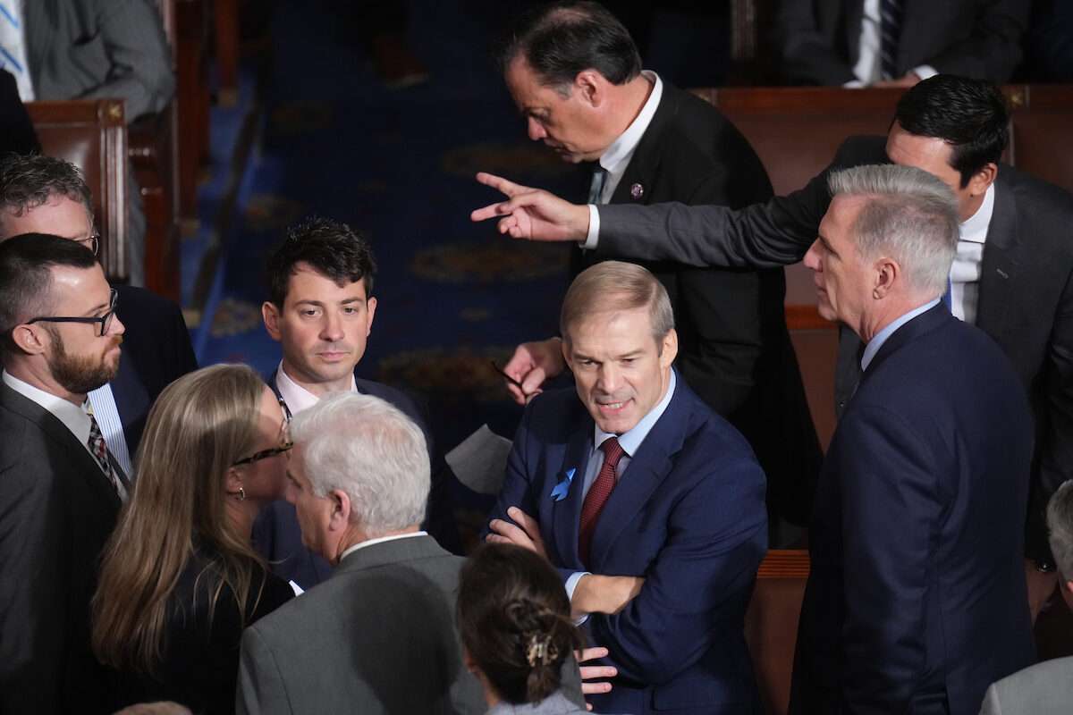 House Judiciary Chairman Jim Jordan, R-Ohio, speaks to aides on the floor as Rep. Kevin McCarthy, R-Calif., looks on. 
