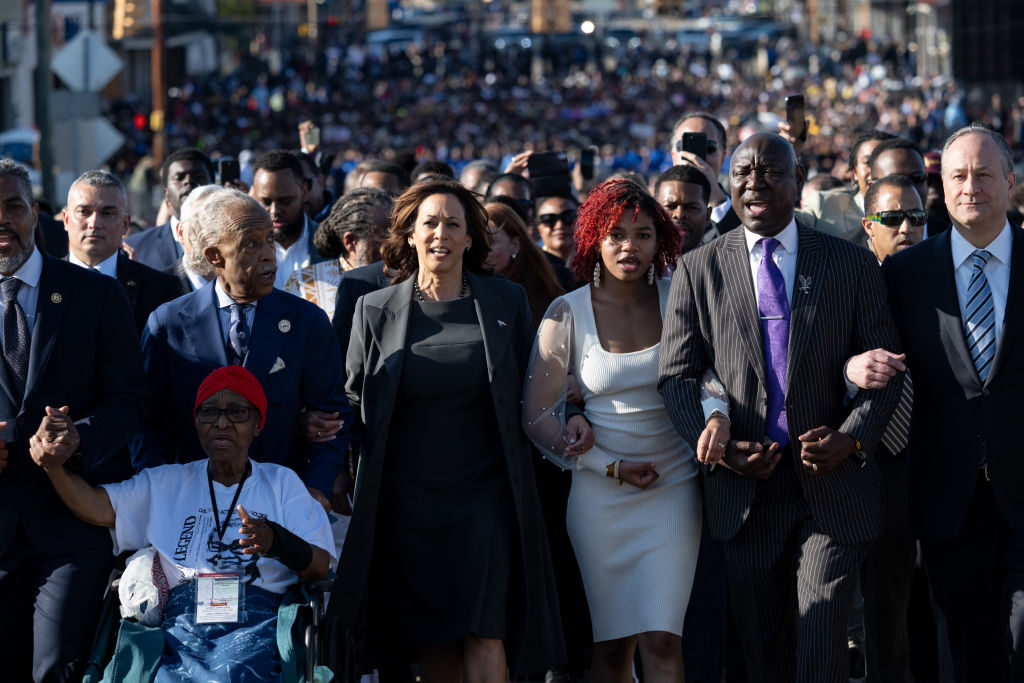 Vice President Kamala Harris (second from left), second gentleman Doug Emhoff (right), civil rights attorney Ben Crump (second from right) and the Rev. Al Sharpton (left) join a march across the Edmund Pettus Bridge during a commemoration of the 59th anniversary of Bloody Sunday in Selma, Ala., on Sunday.