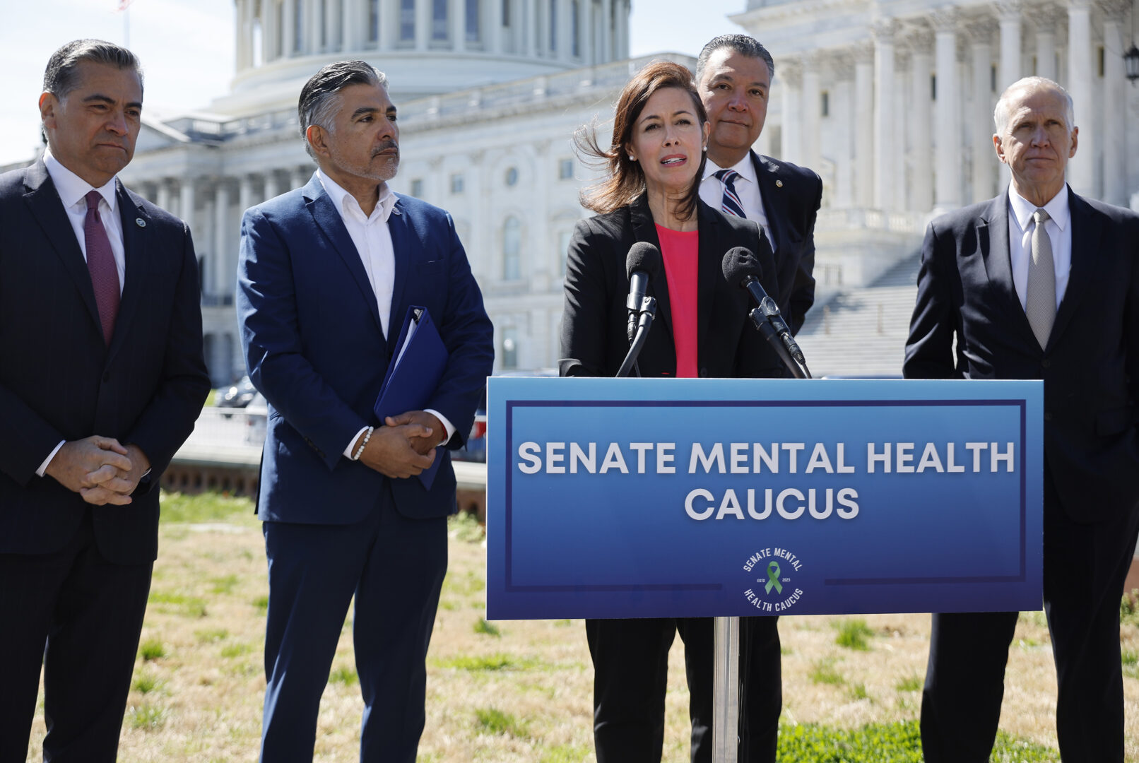 FCC Chairwoman Jessica Rosenworcel joins, from left, HHS Secretary Xavier Becerra, Rep. Tony Cardenas and Senate Mental Health Caucus co-chairs Alex Padilla and Thom Tillis for a news conference outside the Capitol on March 21 to announce new efforts to use geographical data to help people who call the 988 mental health crisis hotline to connect to local help instead of using their telephone number's area code.