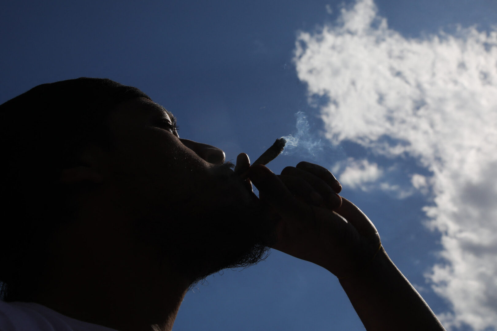 A person smokes marijuana during a 420 celebration at Washington Square Park in New York on April 20, 2024. 