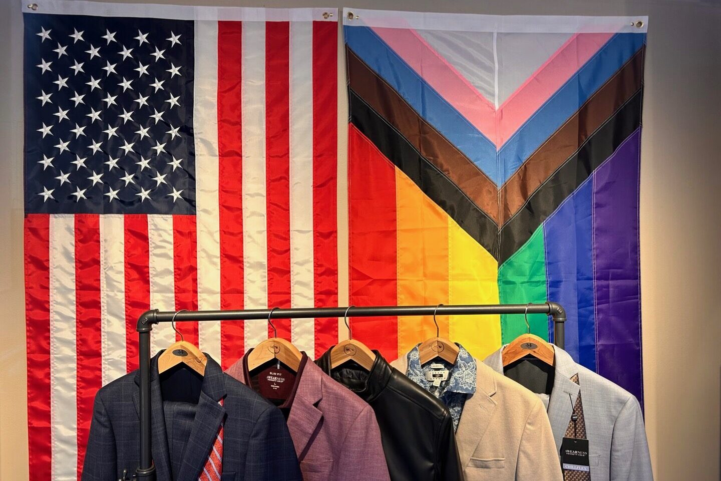 An American flag and a Pride flag hang in a window display at a clothing store celebrating Pride Month, in Queens, N.Y. (Lindsey Nicholson/UCG/Universal Images Group via Getty Images)