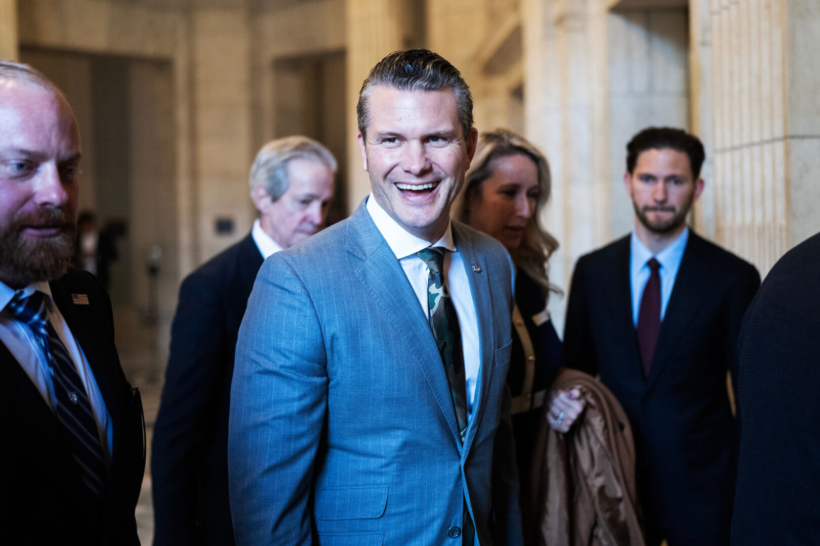 Pete Hegseth, President Donald Trump's Defense secretary pick, and his wife, Jennifer, make their way to a meeting with Sen. John Fetterman, D-Pa., in the Russell Senate Office Building on Dec. 12, 2024.