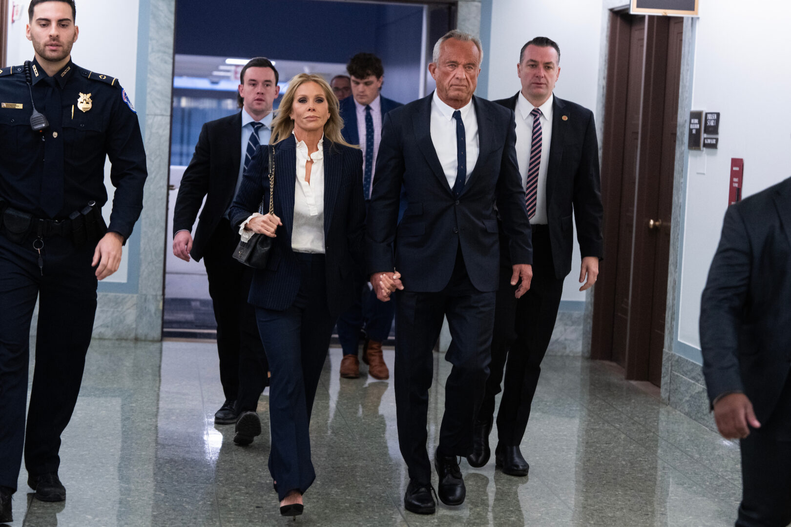 Robert F. Kennedy Jr.,  President Donald Trump's nominee to be secretary of Health and Human Services, and his wife Cheryl Hines, arrive for his Senate Finance Committee confirmation hearing on Wednesday, Jan. 29, 2025. 