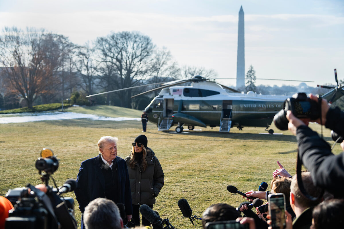 President Donald Trump speaks to reporters on the South Lawn of the White House on Jan. 24 as first lady Melania Trump looks on. (Tom Williams/CQ Roll Call)