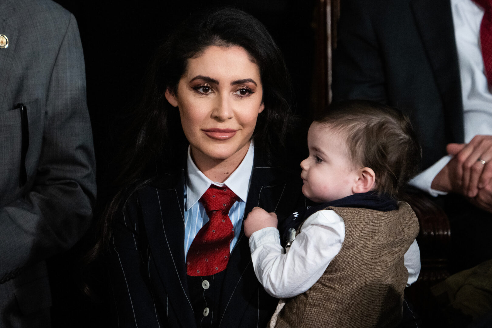 Rep. Anna Paulina Luna, seen here with her child in the House chamber on Jan. 3, is working to bypass leadership and bring to the floor a resolution that would allow proxy voting for new parents in the House.