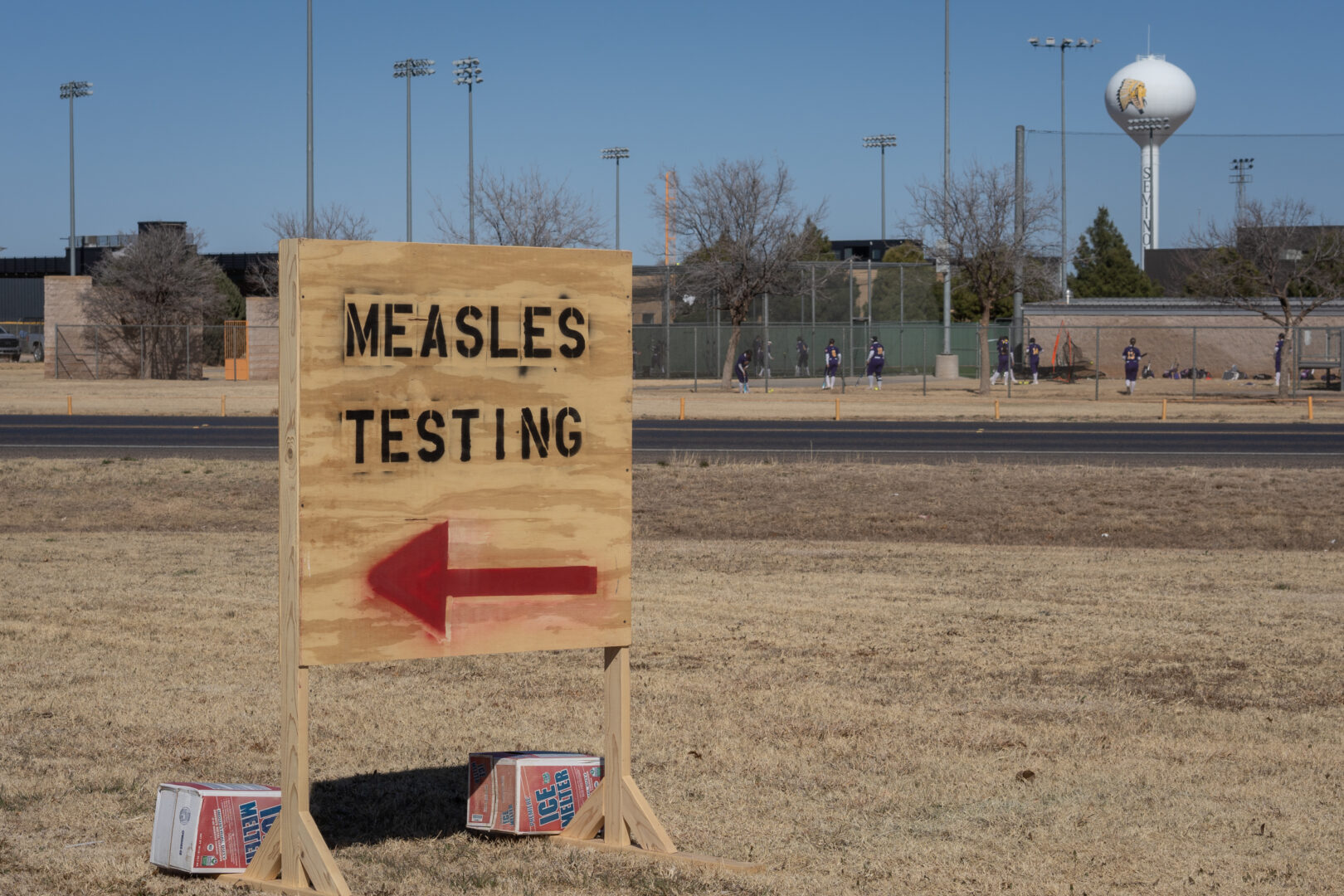 Signs point the way to measles testing in the parking lot of the Seminole Hospital District across from Wigwam Stadium on Feb. 27 in Seminole, Texas.