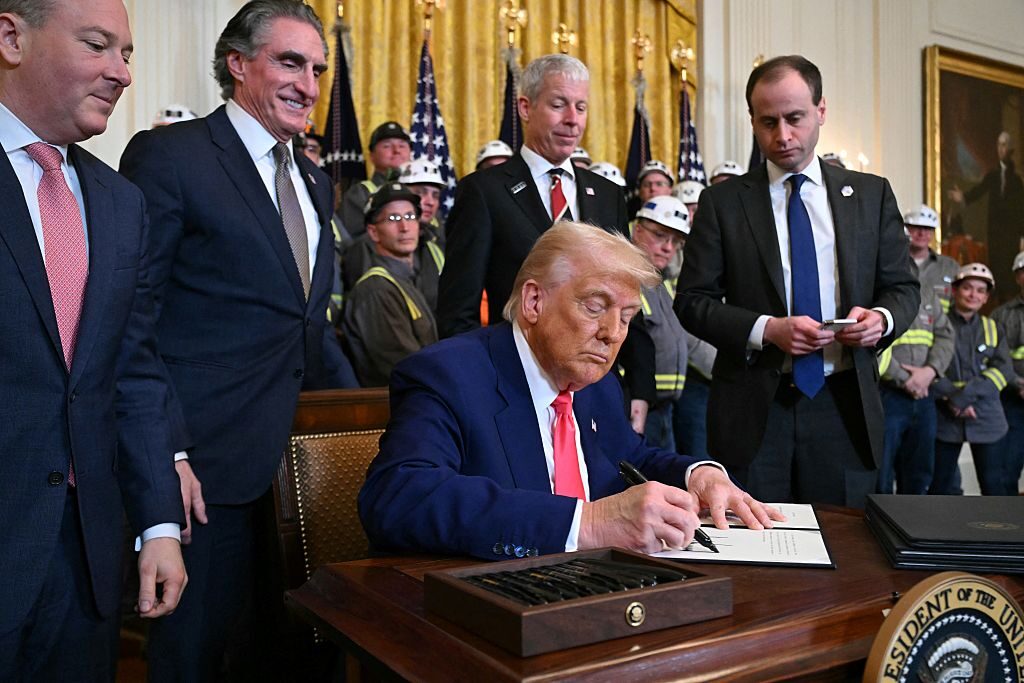 President Donald Trump signs an executive order in the East Room of the White House on Tuesday to boost domestic coal mining and production.