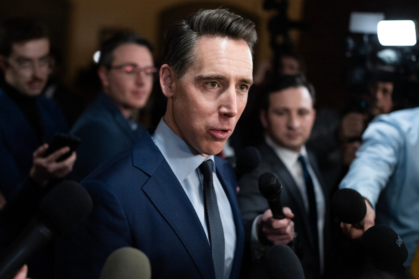 Sen. Josh Hawley, R-Mo., talks with reporters in the Russell Senate Office Building before a Senate vote on Feb. 19. 