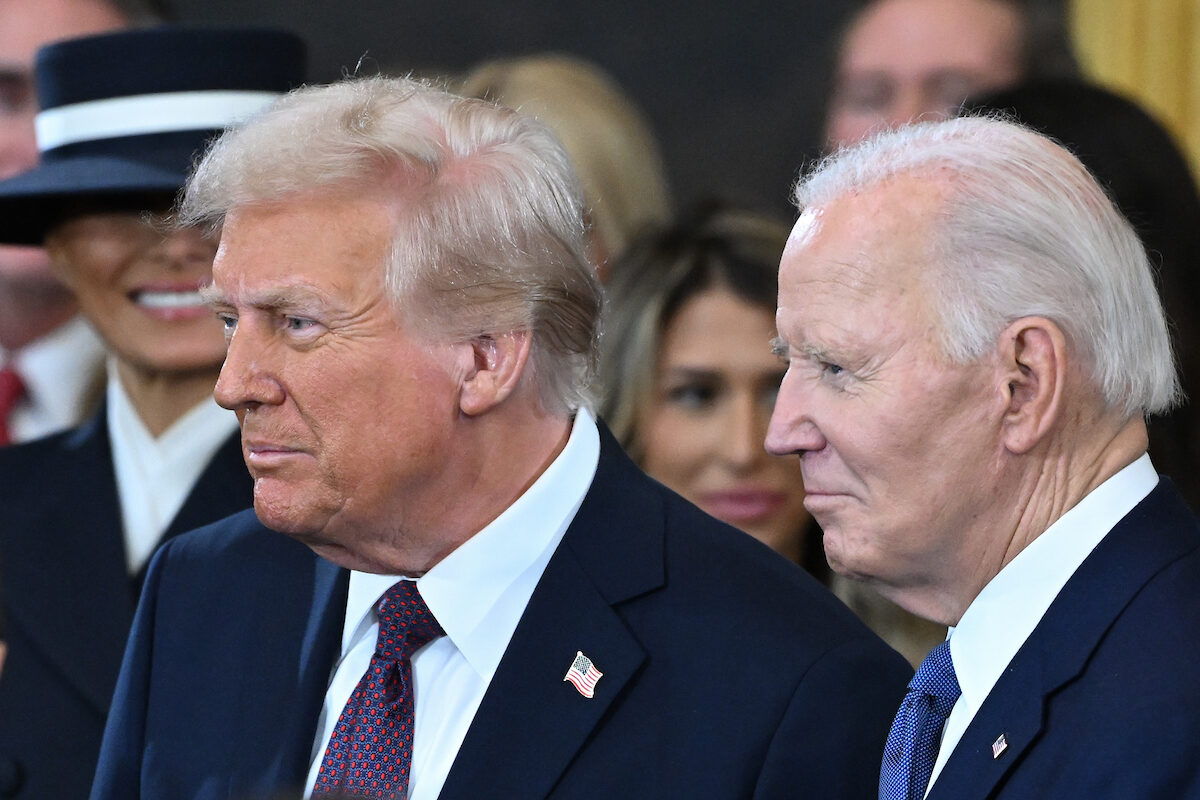 Joe Biden looks on  as Donald Trump arrives for his inauguration ceremony in January. (Saul Loeb/Pool/AFP)