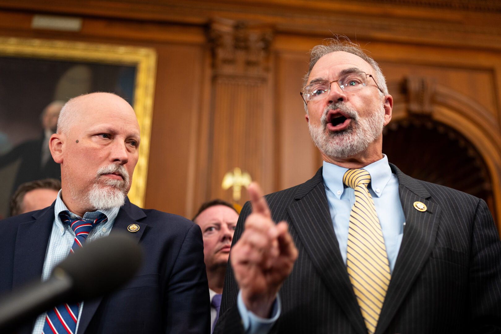 Rep. Chip Roy, R-Texas, left, and House Freedom Caucus Chairman Andy Harris, R-Md., along with other Freedom Caucus members speak to reporters about the reconciliation bill talks in the Capitol on Wednesday. 