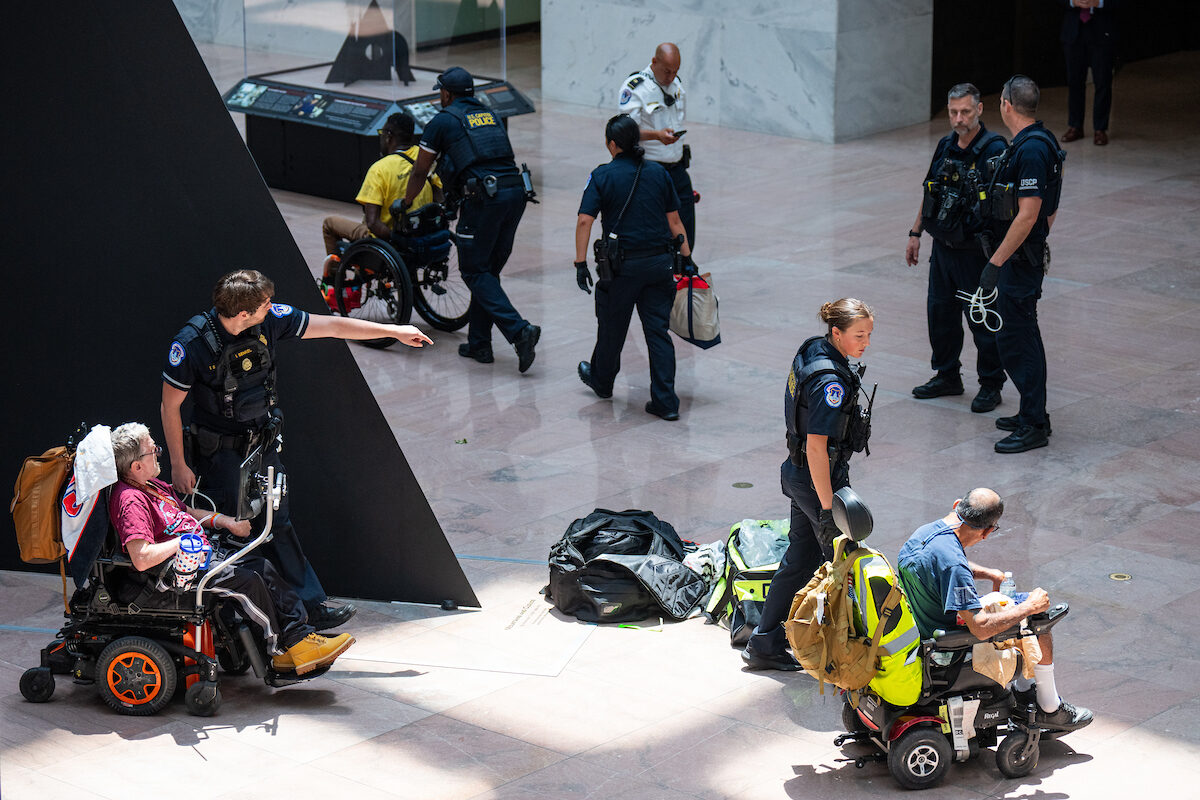 U.S. Capitol Police arrest protesting members of American Disabled for Attendant Programs Today (ADAPT) in the atrium of the Hart Senate Office Building on Tuesday. The protesters chanted “no cuts to Medicaid” while being arrested.