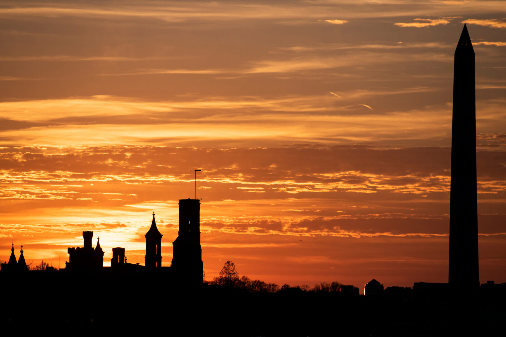A nascent Smithsonian museum has run into another potential roadblock as President Donald Trump takes aim at funding. Above, the Washington Monument and Smithsonian Castle are seen silhouetted at sunset.