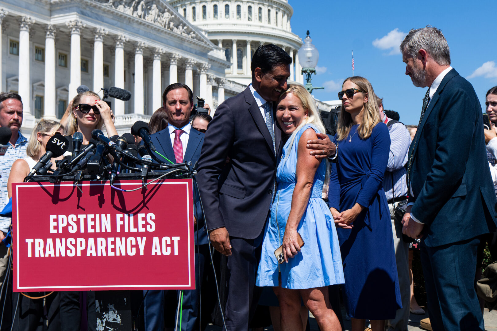 Rep. Ro Khanna, D-Calif., hugs Rep. Marjorie Taylor Greene, R-Ga., during Wednesday’s news conference with Epstein survivors. 