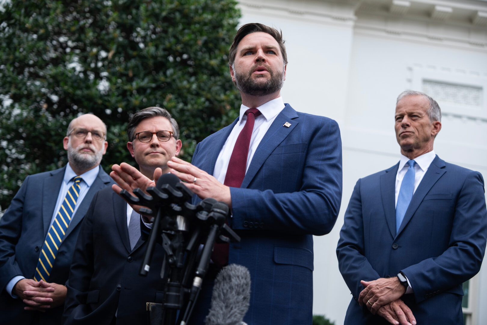 Vice President JD Vance, at podium; Senate Majority Leader John Thune, right; Speaker Mike Johnson, second from left; and Office of Management and Budget Director Russ Vought conduct a news conference after a meeting with President Donald Trump and top Democratic leaders at the White House on Monday. 