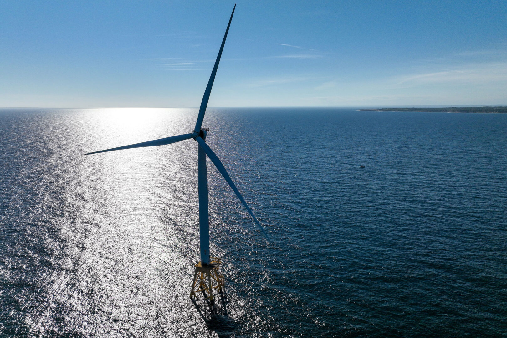 In an aerial view, a wind turbine generates electricity at the Block Island Wind Farm on July 07, 2022, near Block Island, R.I. 