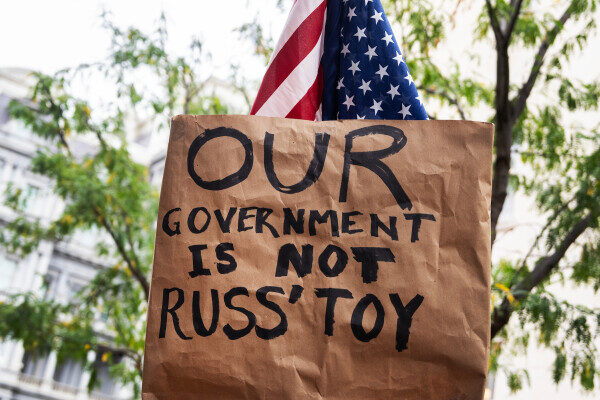 A sign displayed at a news conference with Democratic lawmakers on Tuesday reads, "Our government is not Russ' toy," referring to White House budget director Russ Vought. (Tom Williams/CQ Roll Call)
