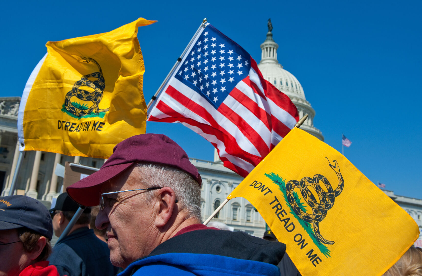 Tea party activists gather near the Capitol on April 6, 2012, holding “Don’t Tread on Me” flags.