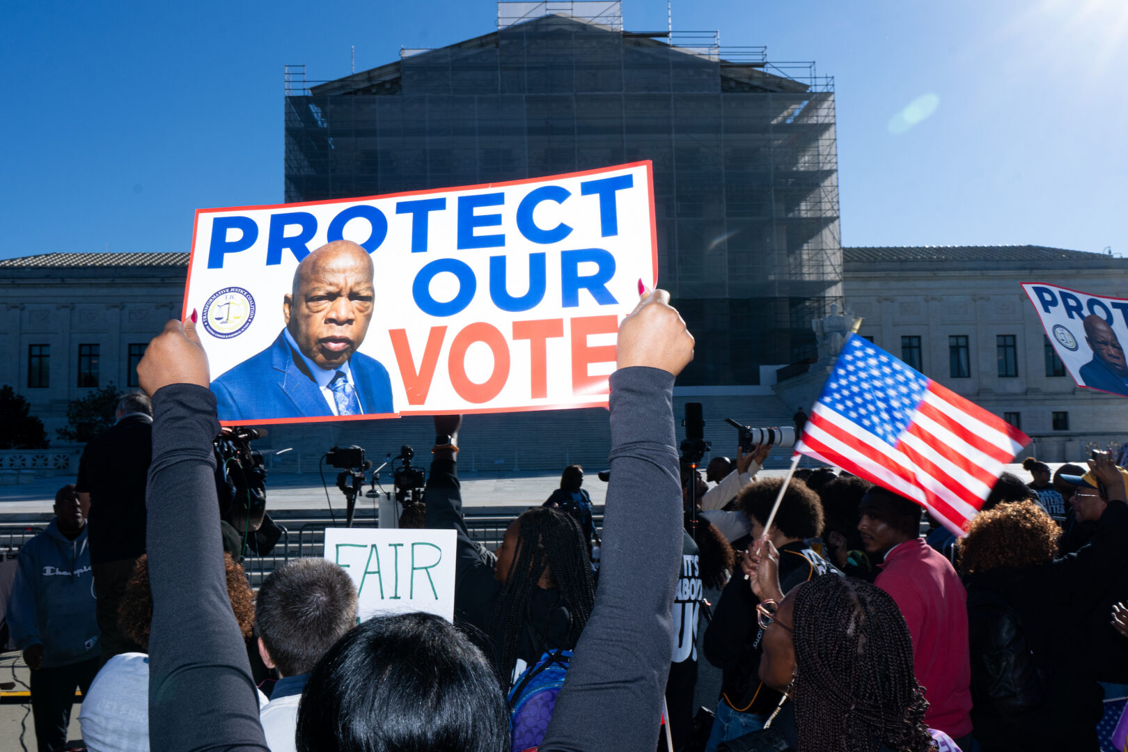 Voting rights activists protest Wednesday outside the Supreme Court in Washington as the court prepares to hear arguments in a case challenging Louisiana's congressional map.