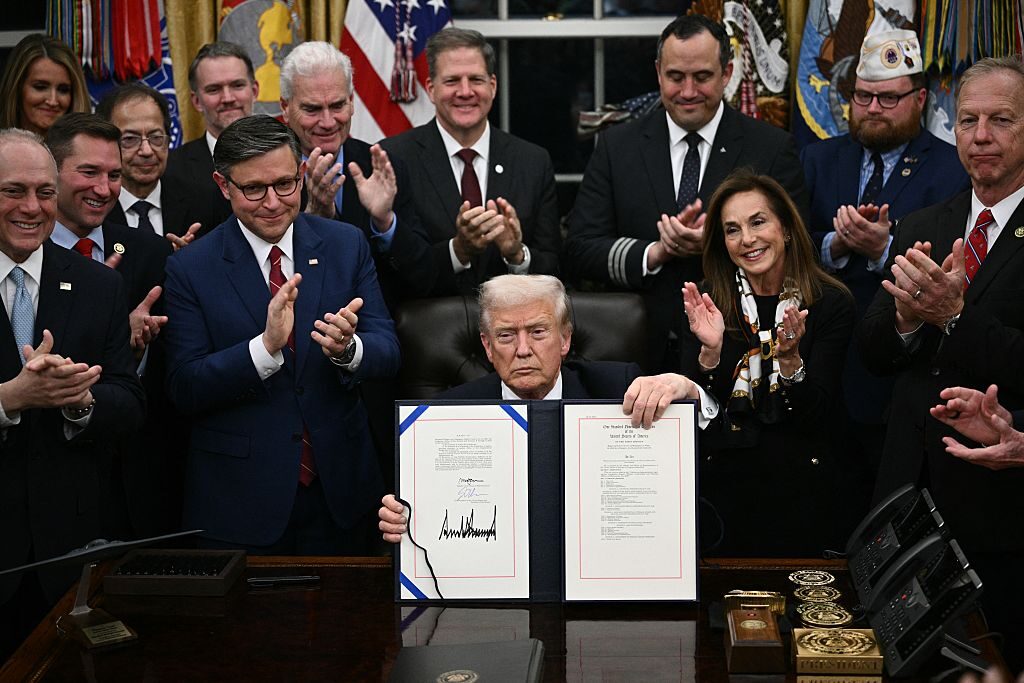 President Donald Trump shows the signed bill to reopen the federal government in the Oval Office of the White House Wednesday night. Trump was joined by Speaker Mike Johnson, R-La., other key congressional Republicans, administration officials and business leaders.