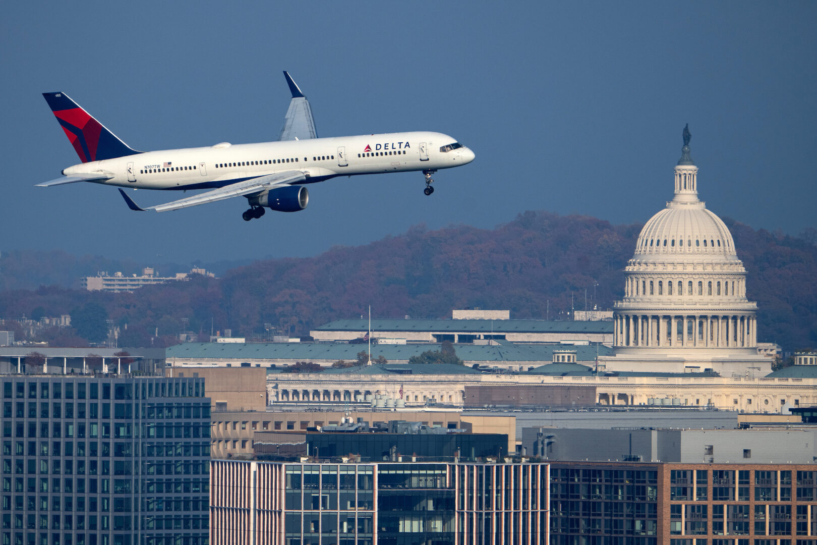 A Delta Airlines Boeing 757-200 plane passes by the Capitol dome in Washington as it comes in for a landing at Ronald Reagan Washington National Airport on Sunday.
