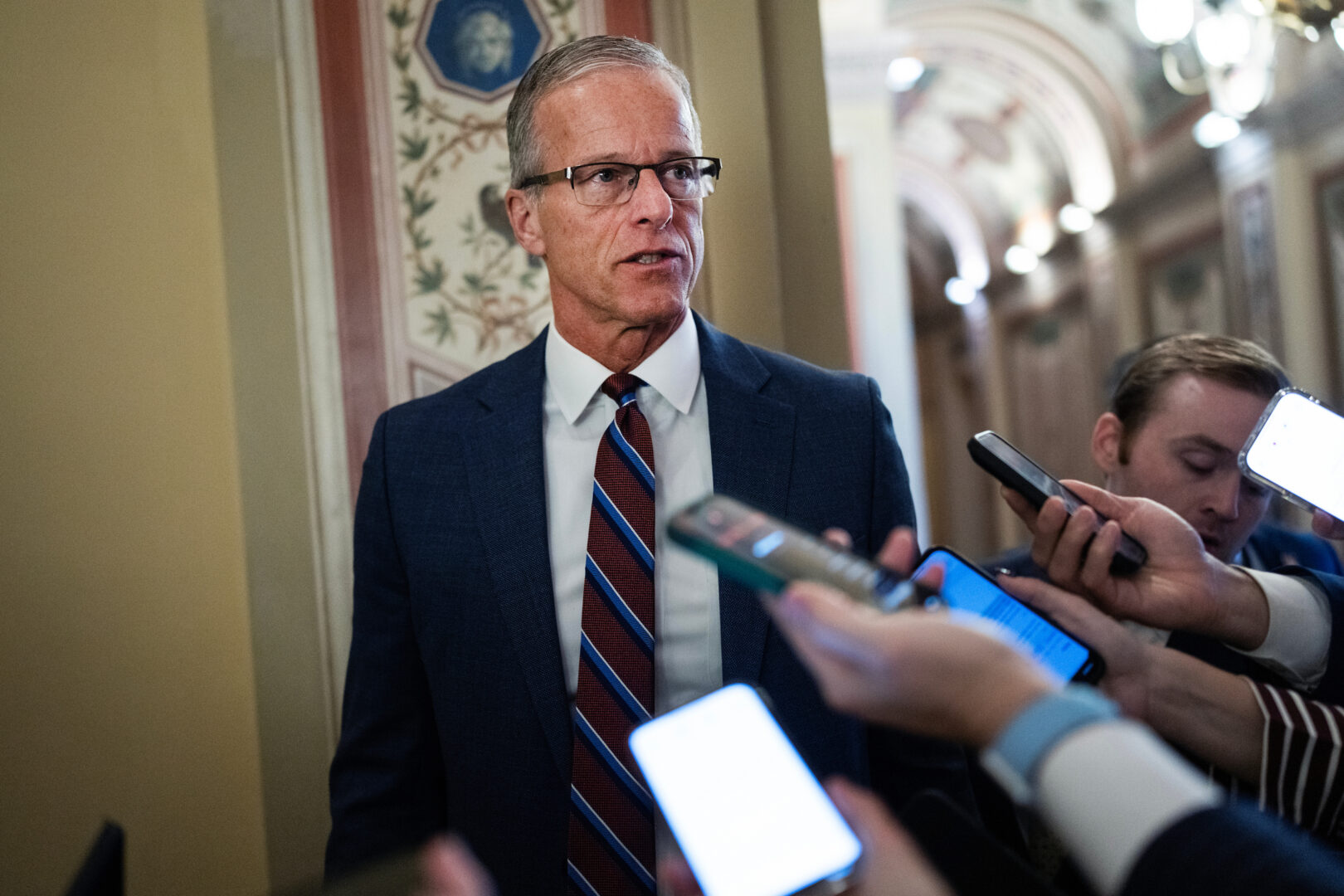 Senate Majority Leader John Thune talks with reporters on Monday. 