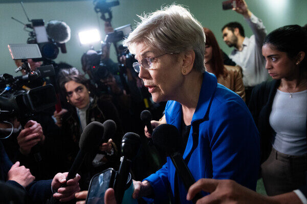 Warren talks with reporters in the Dirksen Senate Office Building on Oct. 29.  (Tom Williams/CQ Roll Call)
