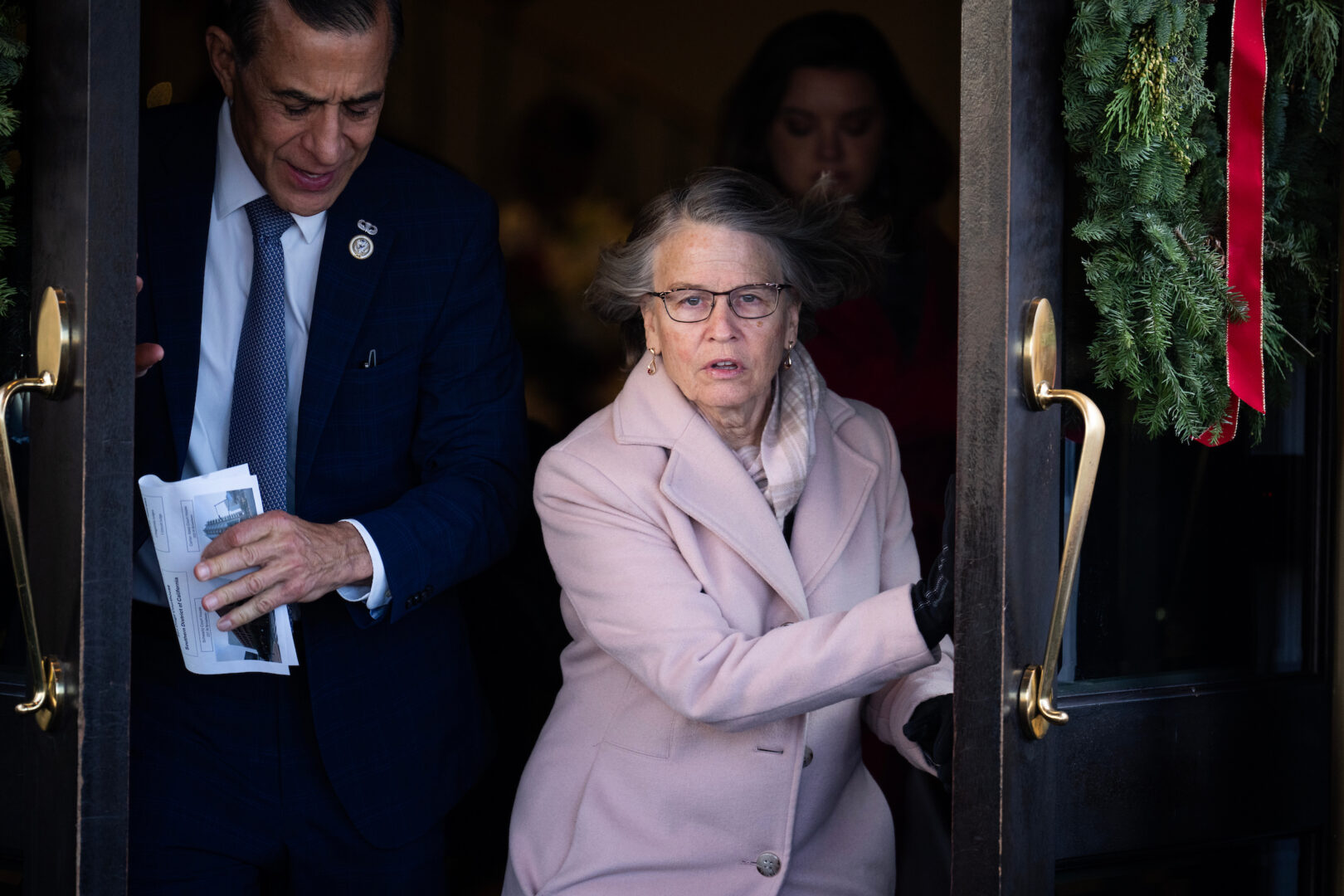 Reps. Mariannette Miller-Meeks, R-Iowa, and Darrell Issa, R-Calif., leave a meeting of the House Republican Conference at the Capitol Hill Club on Dec. 4, 2024. 