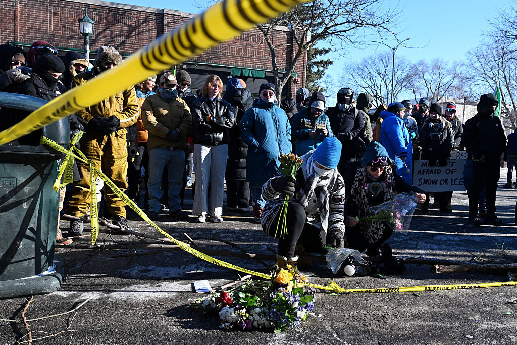 People pay their respects near where a man was shot and killed by federal immigration agents in Minneapolis on Jan. 24. 