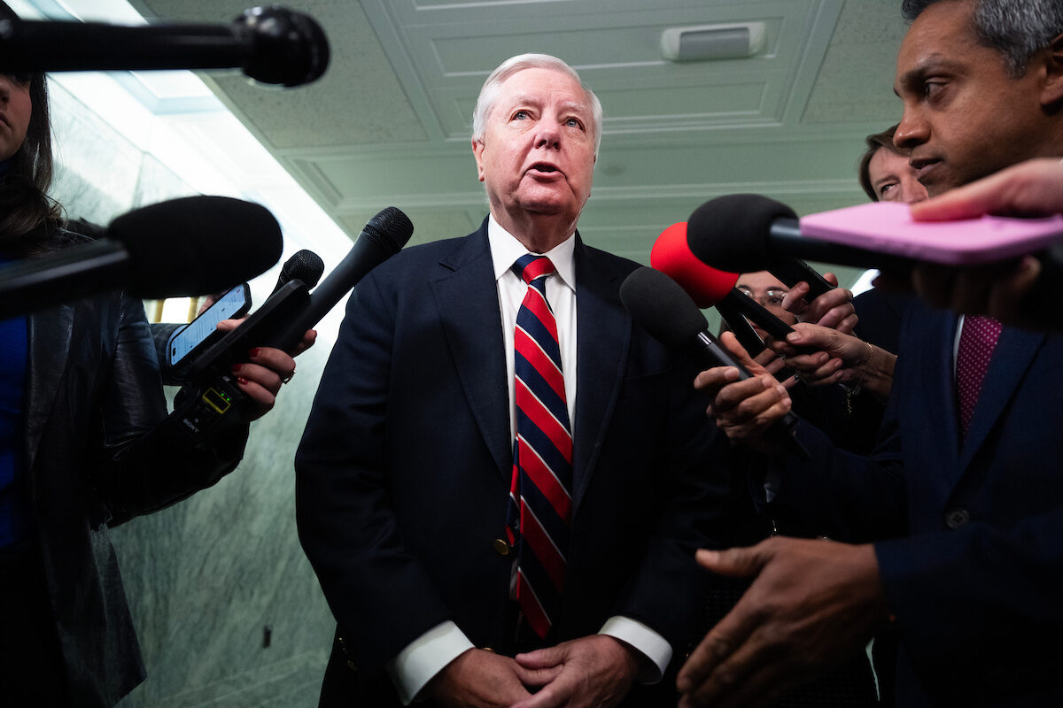 South Carolina Sen. Lindsey Graham talks with reporters in the Dirksen building on Dec. 9. (Tom Williams/CQ Roll Call)