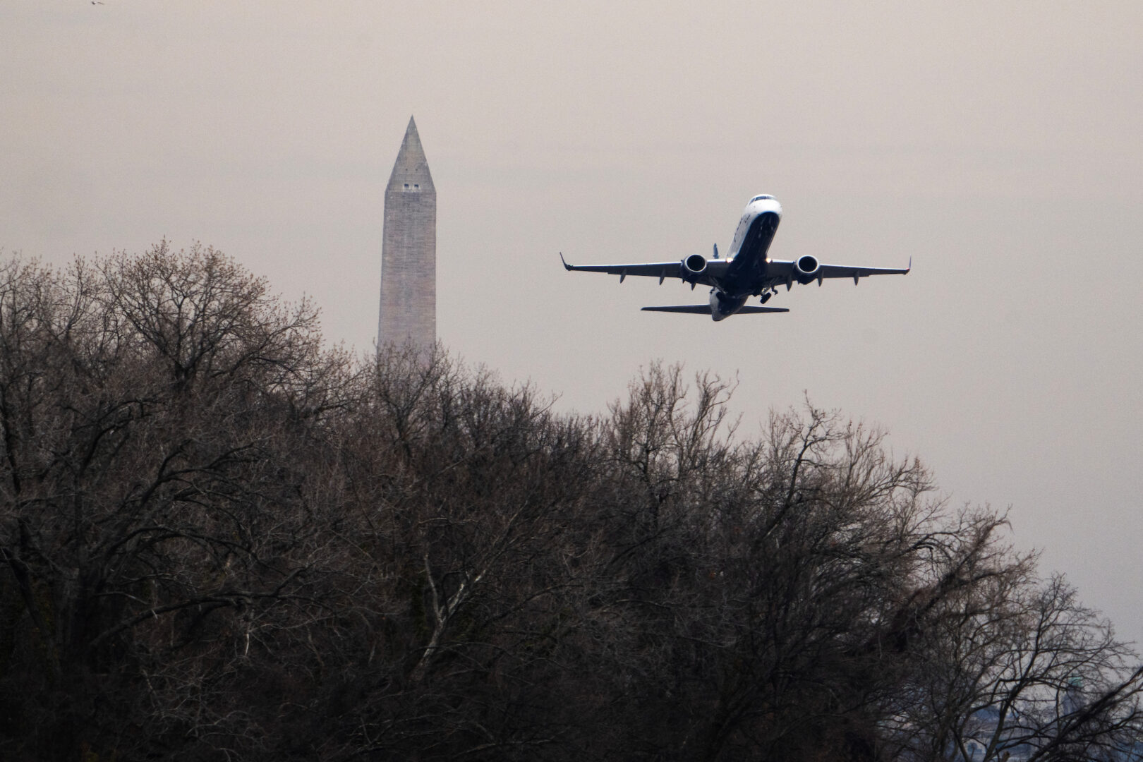 A plane takes off from Ronald Reagan Washington National Airport near the wreckage of American Airlines Flight 5342 in the Potomac River on Feb. 3, 2025.