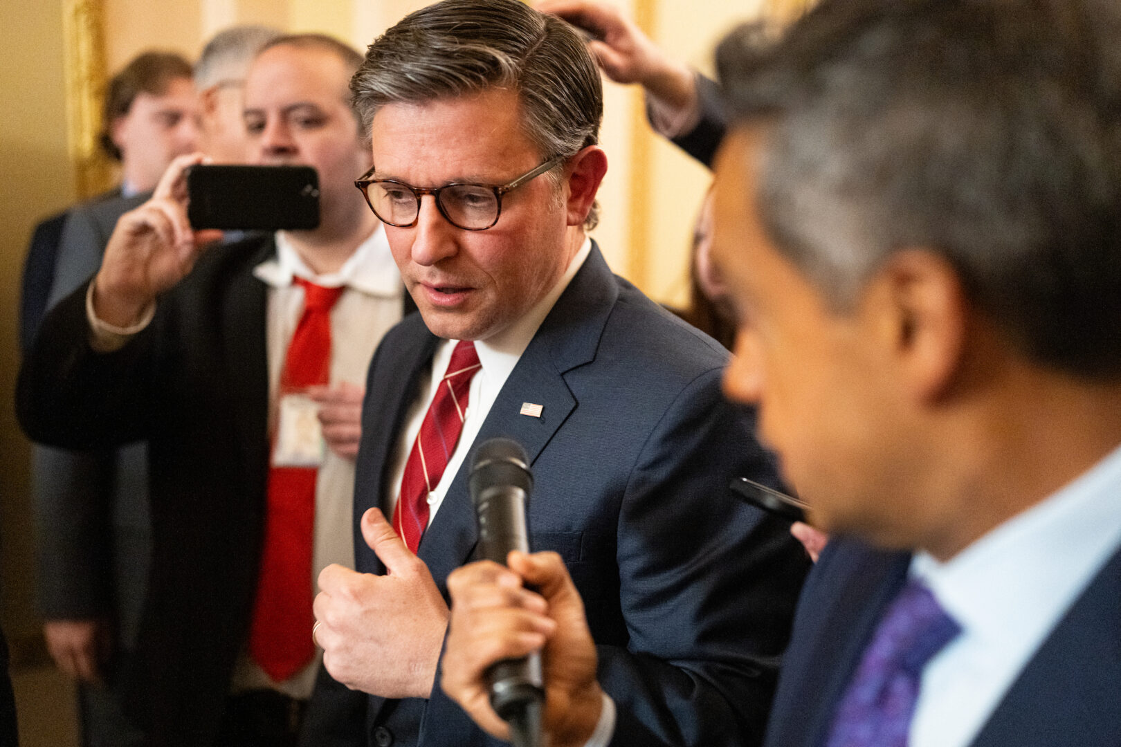 Speaker Mike Johnson, R-La., speaks to reporters as he leaves the House floor following the close vote on the rule for the government funding bill in the Capitol on Tuesday.