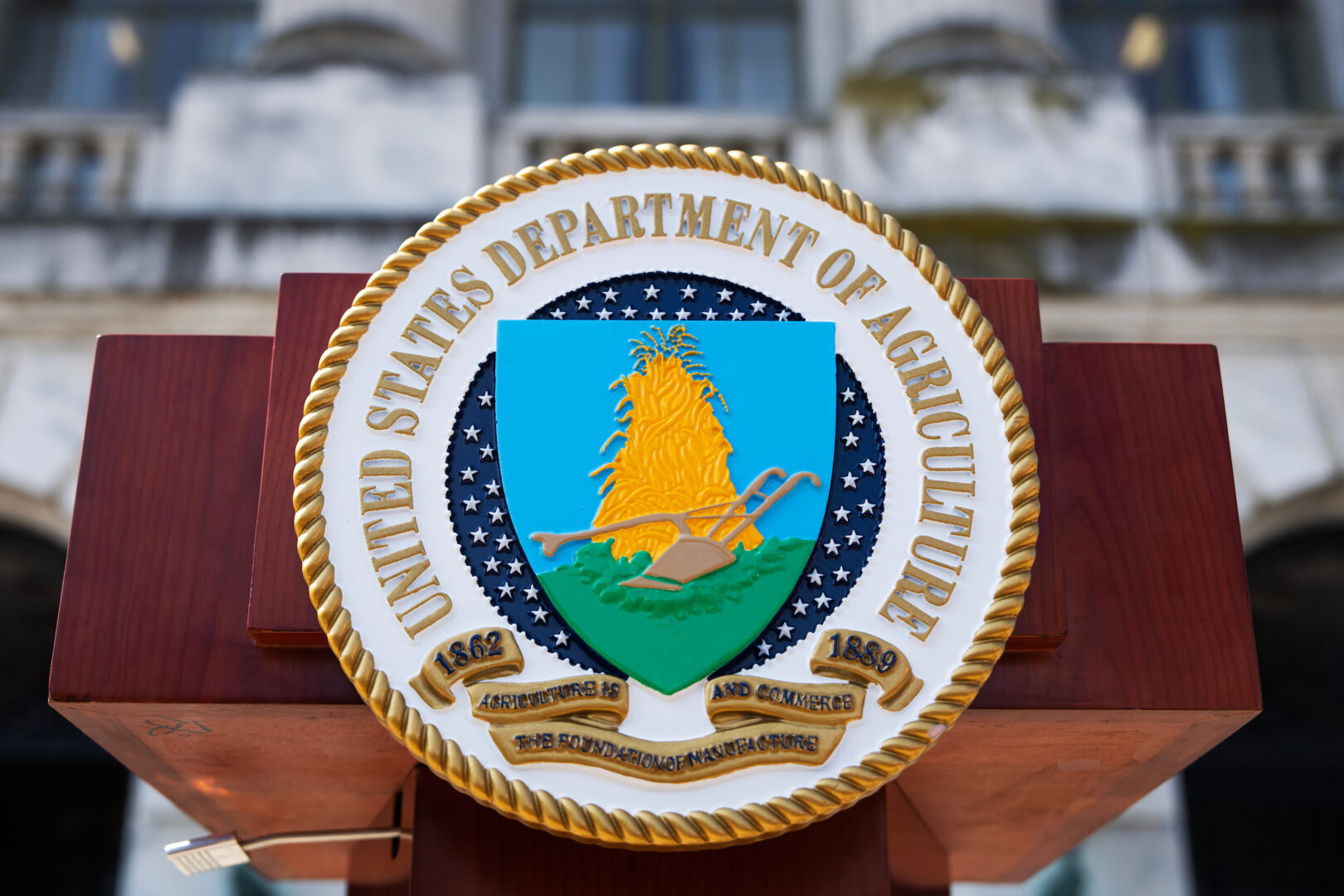 The seal of the Department of Agriculture is seen at a news conference. 