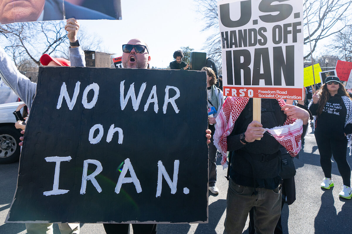 Protesters hold signs and chant during a demonstration outside the White House against President Trump and strikes on Iran on Feb. 28.
