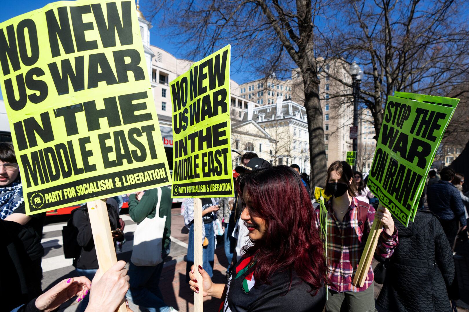 Protesters hold signs and chant during a demonstration outside the White House against President Trump and strikes on Iran on Feb. 28.