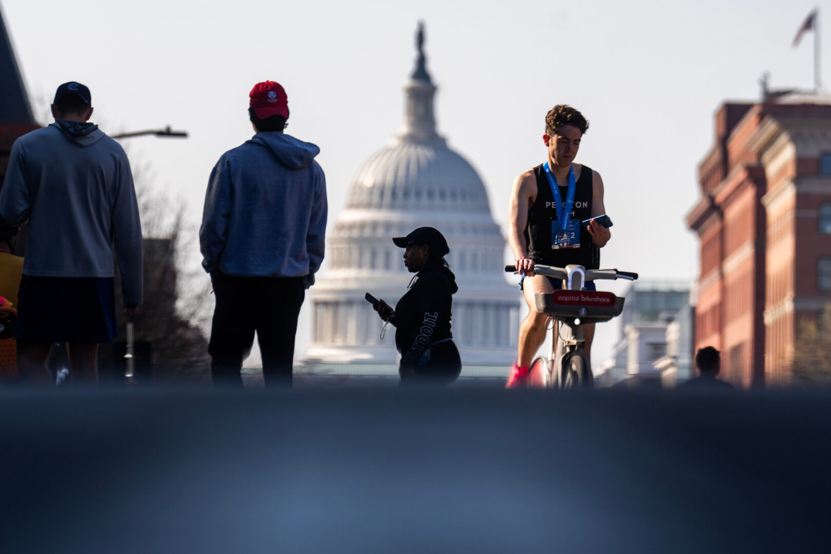 Spectators are seen on North Capitol Street during the Rock 'n' Roll Half Marathon on Saturday. Lawmakers are eager to get out of town for their spring recess.