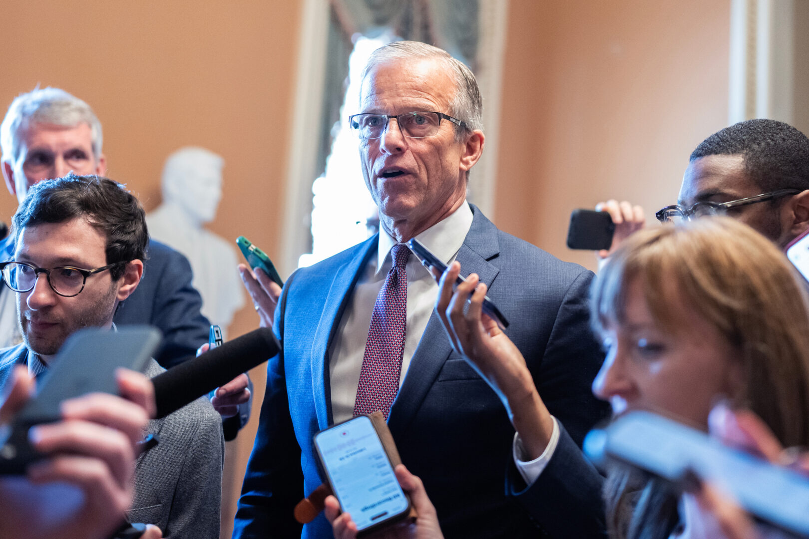 Senate Majority Leader John Thune, R-S.D., talks with reporters in the Capitol about DHS funding on Thursday.