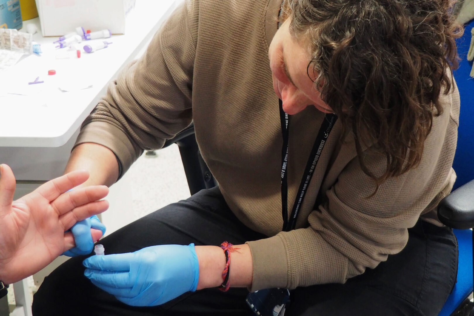 Dr. Kate Robson draws blood at a March hepatitis C testing event in Bristol, England. Wide-scale testing has been key to England’s hepatitis C elimination plan.