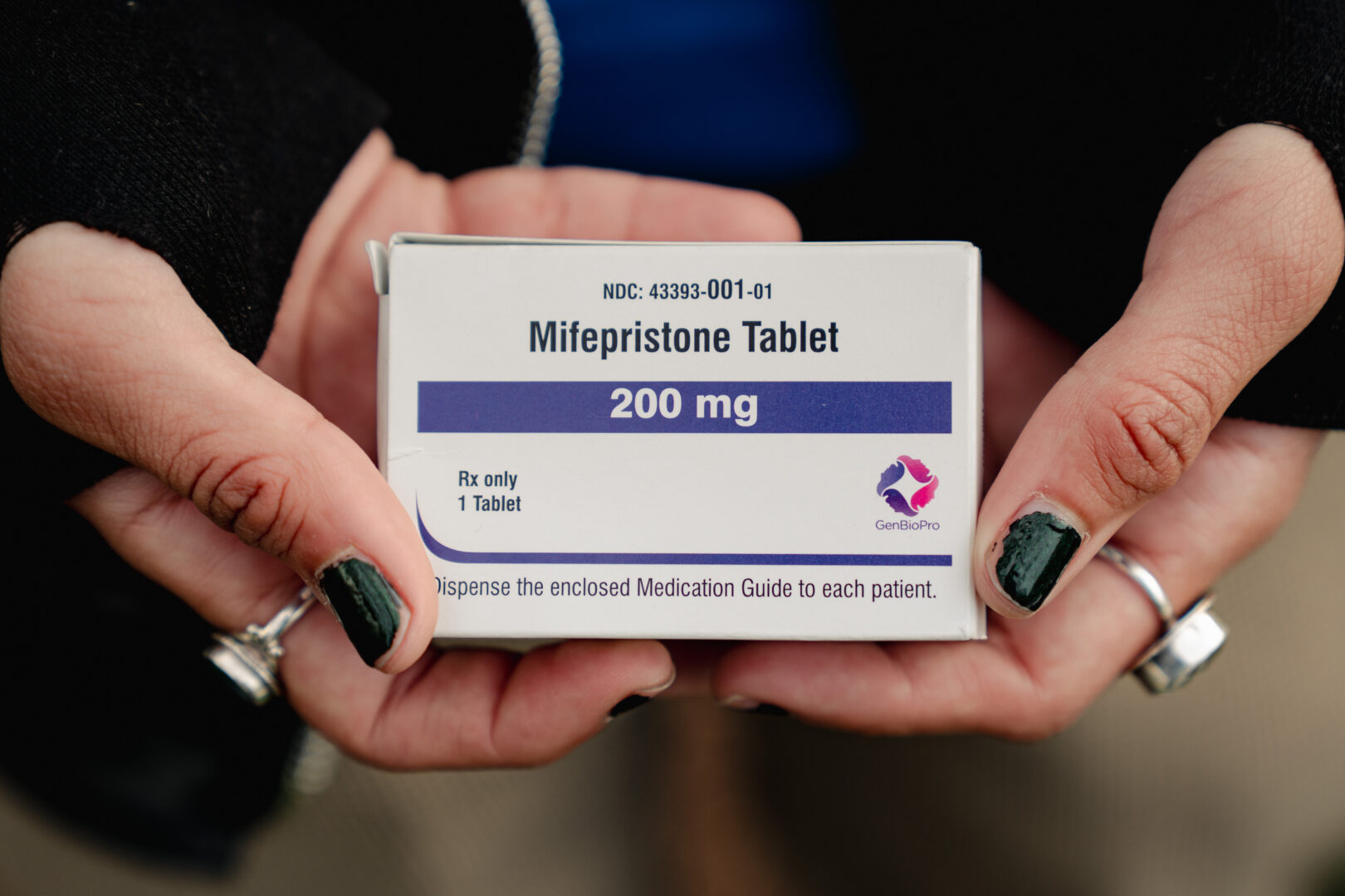 An abortion rights advocate holds a box of mifepristone outside the Supreme Court on March 26, 2024. (Shuran Huang/The Washington Post via Getty Images)