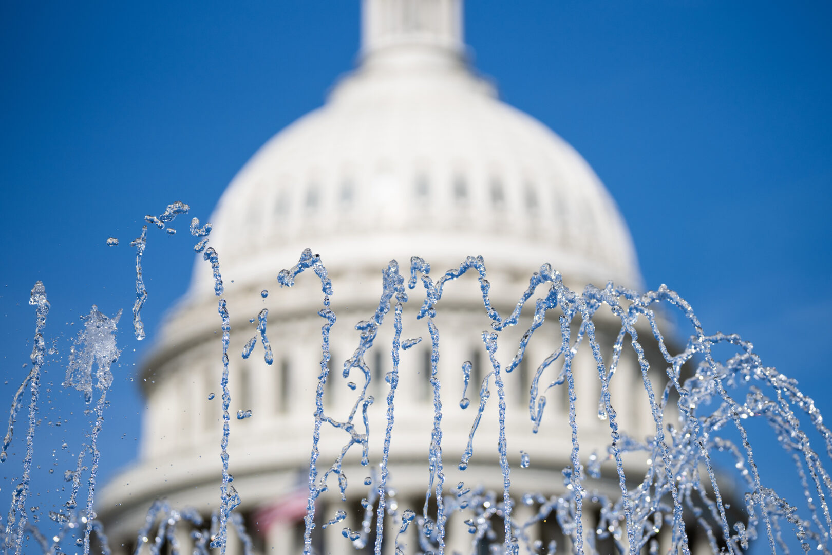 Water from a fountain shoots in the air outside the Capitol. Summer in D.C. is often muggy, hot and filled with legislative angst.  