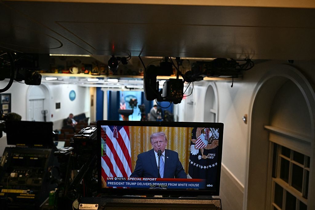 A screen showing President Donald Trump's address to the nation is seen in the James S. Brady Press Briefing Room at the White House on Thursday night as he delivers an address from the nearby East Room.