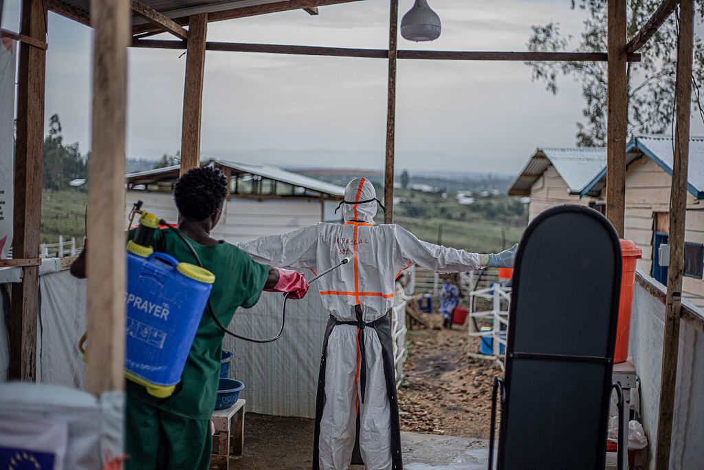 A hygiene specialist decontaminates a doctor leaving the patient care unit of the Rwampara Ebola Treatment Center in Bunia, Ituri, in the east of the Democratic Republic of Congo last month. 