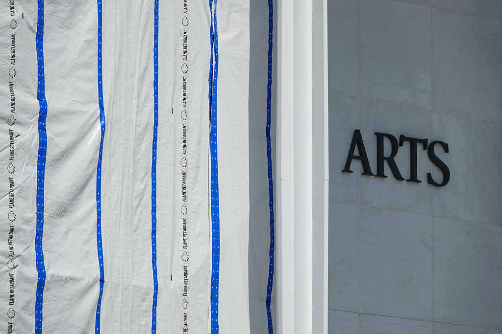 Scaffolding with a tarp stands in front of the Kennedy Center in August, covering the place where President Donald Trump's name was removed. 