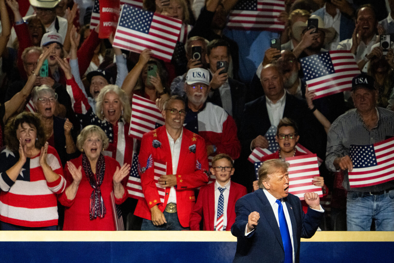 President Donald Trump dances after speaking to the Republican midterm convention in Dallas on Sept. 9. Part of his message? “Pretend that I’m on the ballot.” 