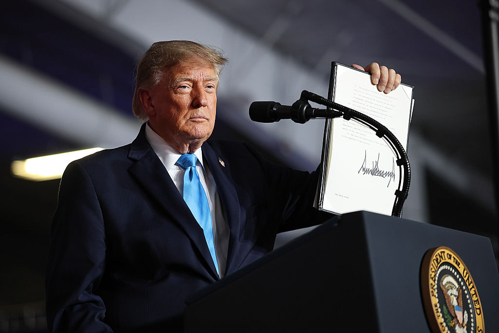President Donald Trump signs an executive order he said would lower the cost of diesel fuel at a rally Tuesday in Nebraska.  (Win McNamee/Getty Images)